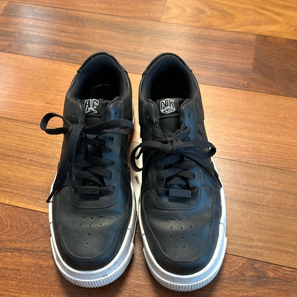 Black womens Nike Air Force low tops.